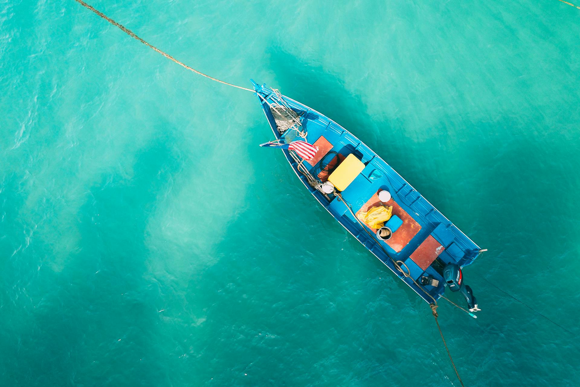 Small boat floating on calm water