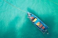Boat floating on calm turquoise water