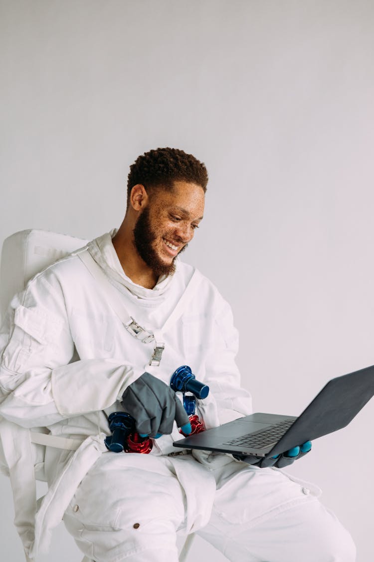 Man In A Costume Holding A Laptop