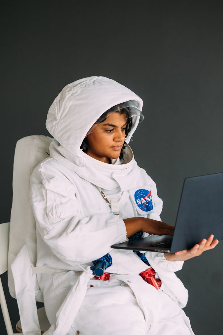 Woman In A Costume Holding A Laptop