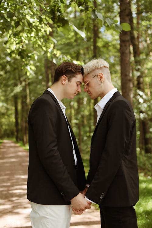 Couple Standing Face to Face while Holding Hands