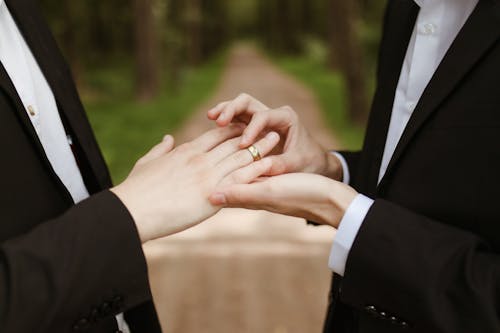 Couple Putting Golden Ring on Finger