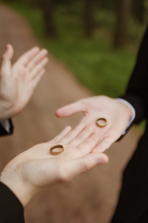 Free Person Holding Gold Wedding Band Stock Photo