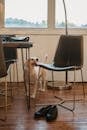 Labrador Retriever with tongue out standing near modern furniture and footwear in stylish room