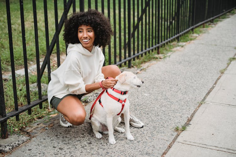 Positive Black Woman On Sidewalk With Dog