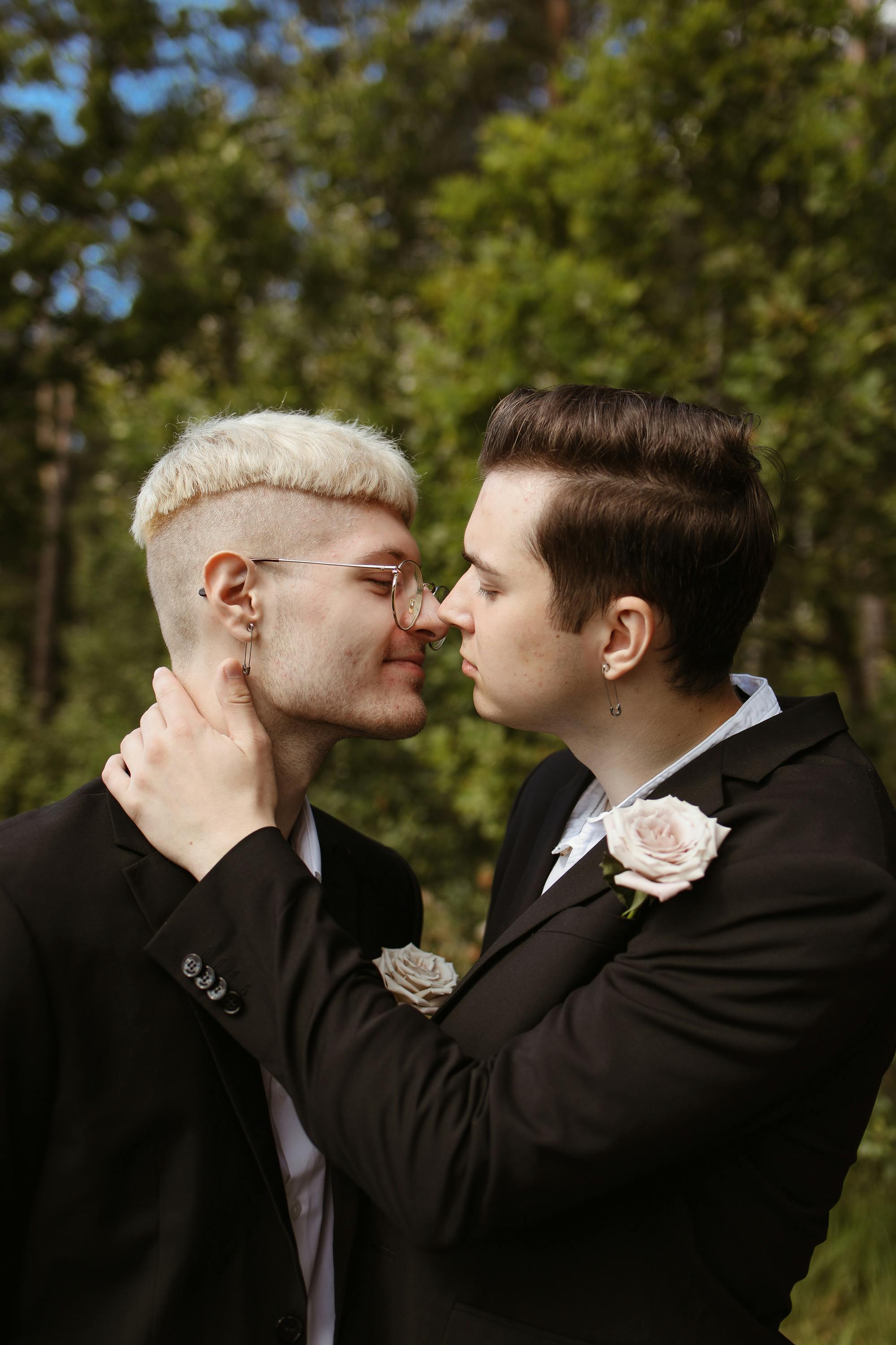 men in elegant suits kissing