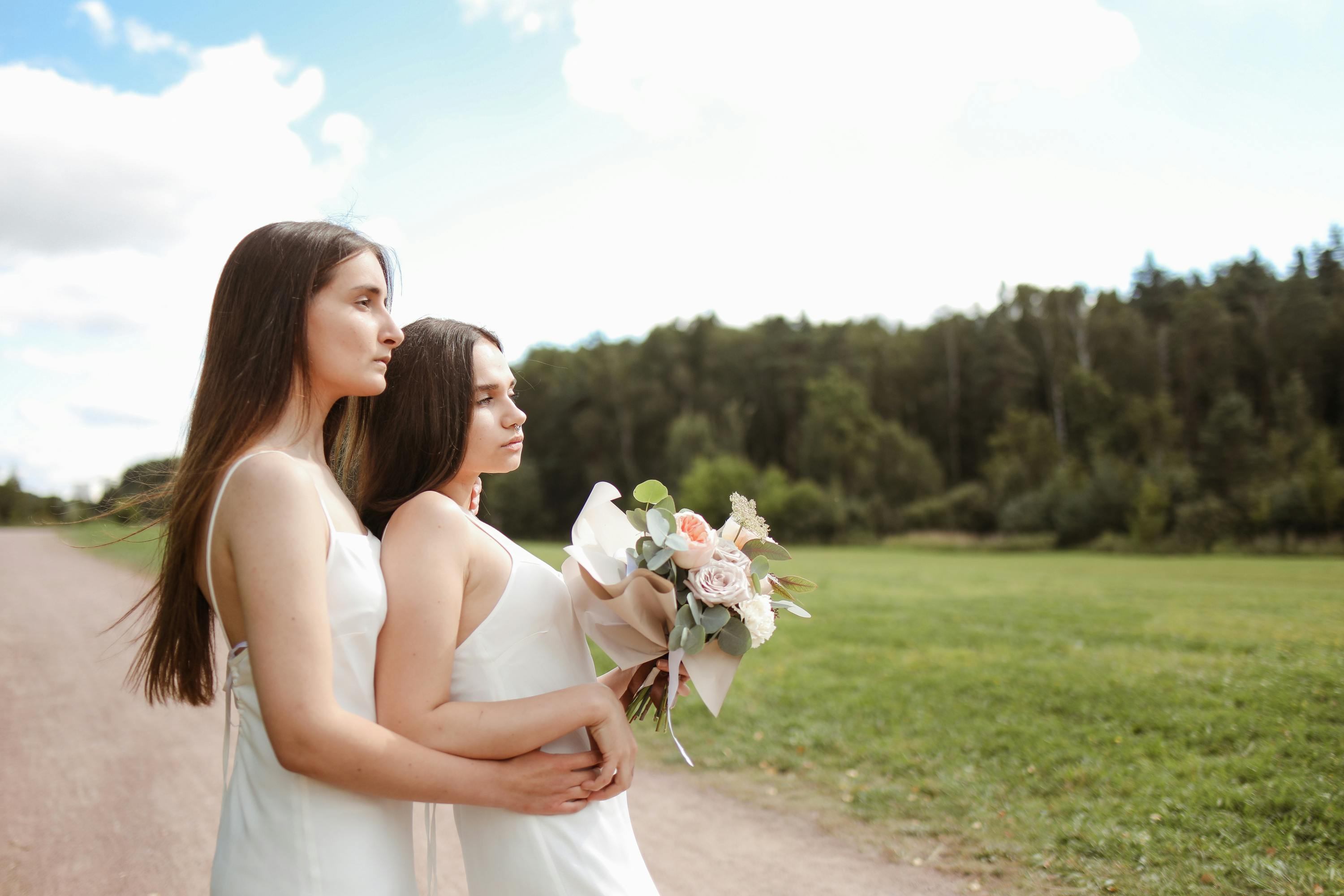 women with bouquet showing affection