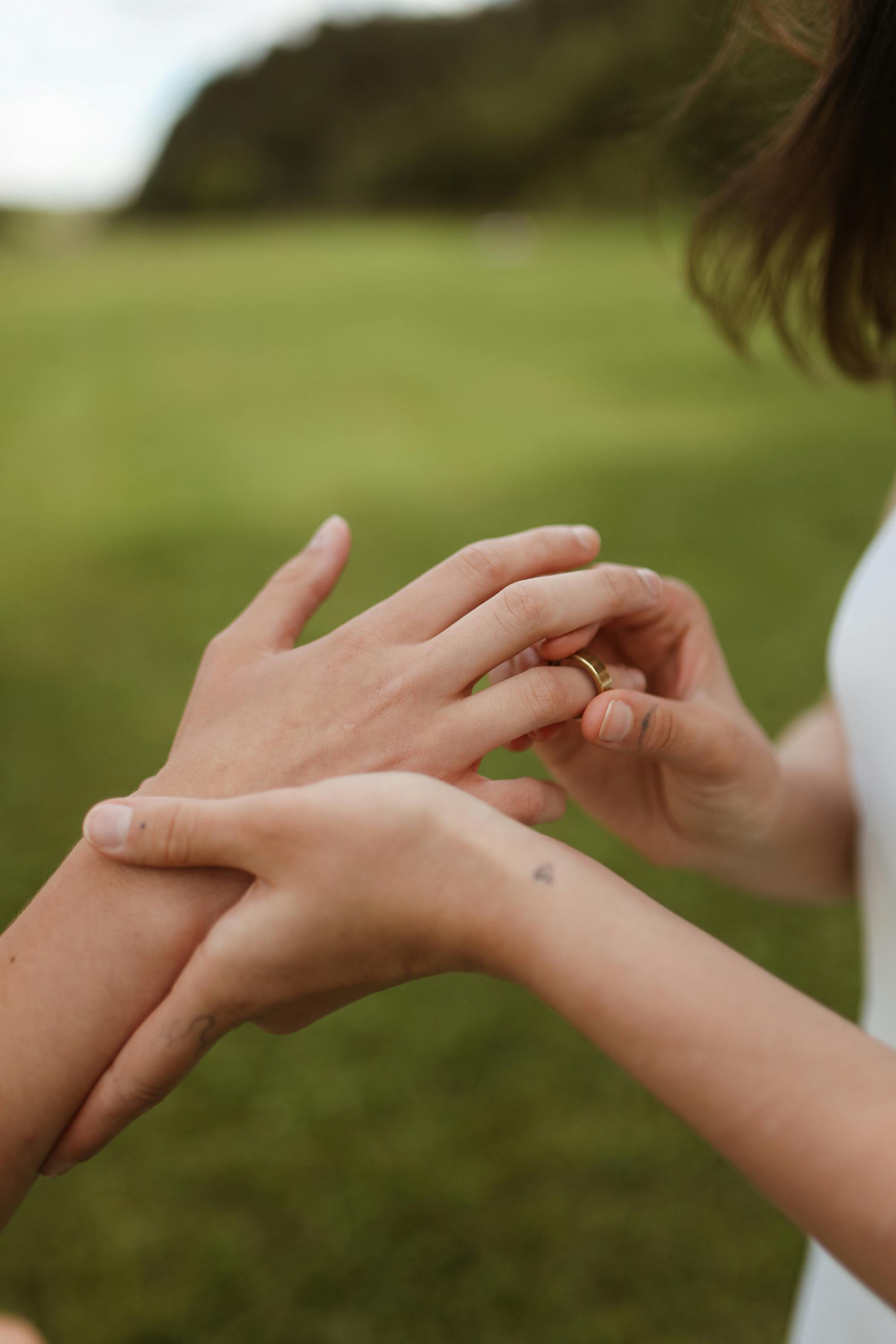 a person wearing a gold ring