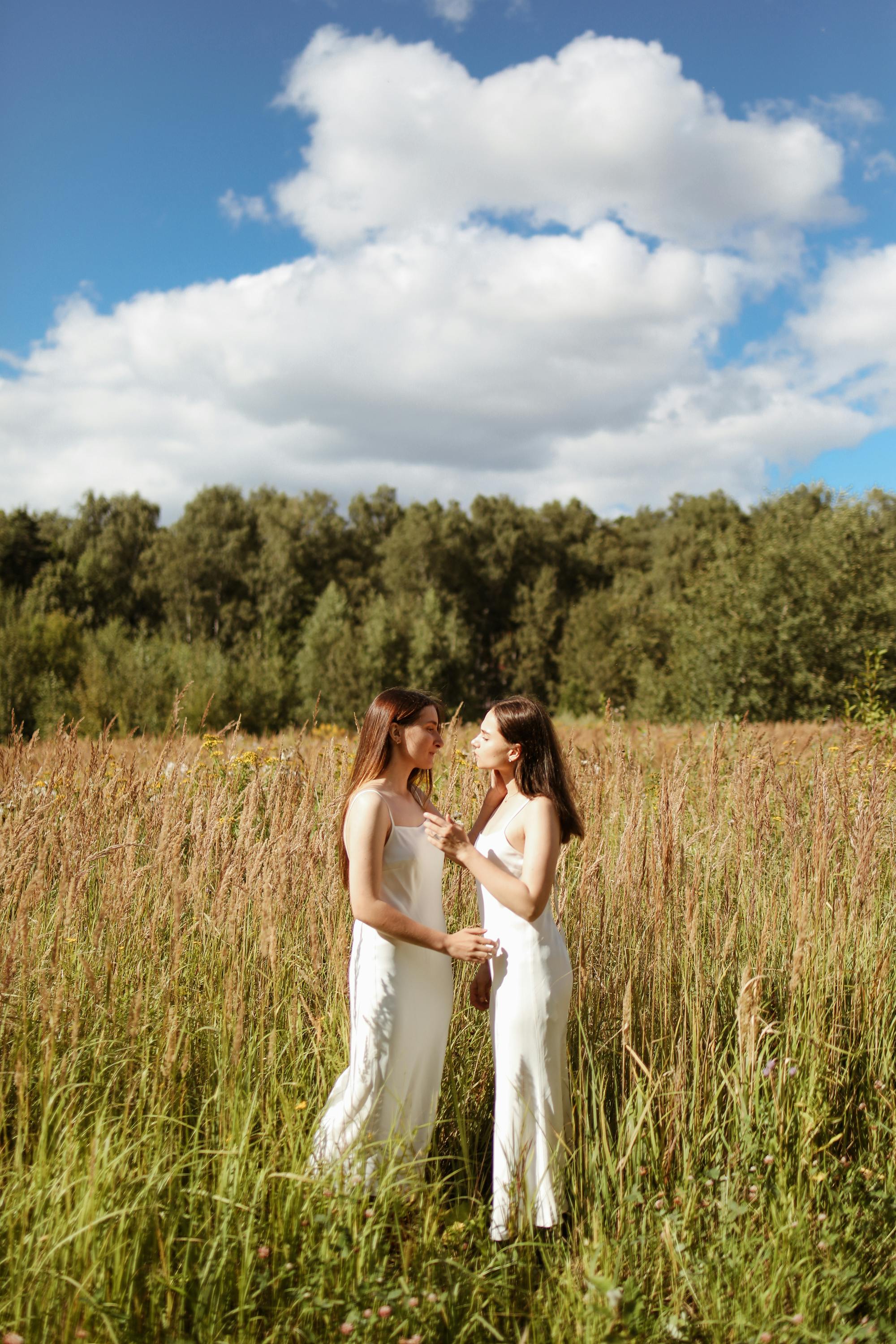 women in a paddy field showing affection to each other