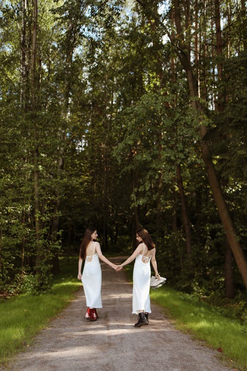 Women in White Dress Standing in Between Trees