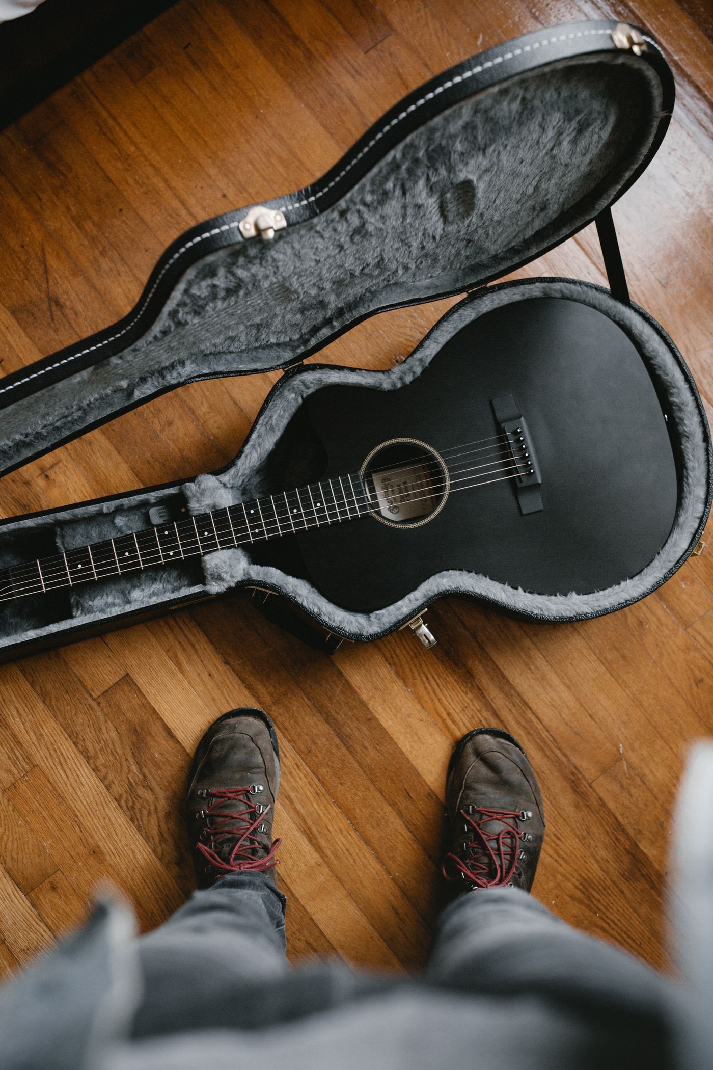 An acoustic guitar resting on a guitar stand