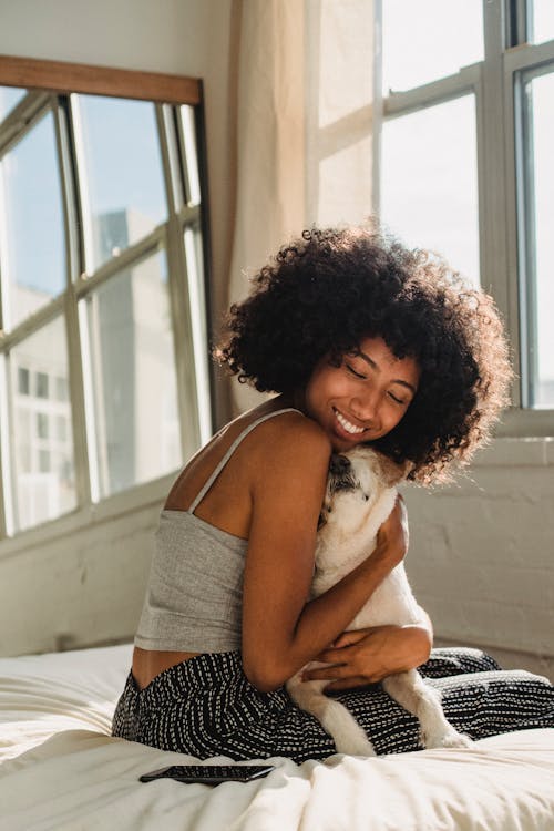 A Woman Hugging the Dog 