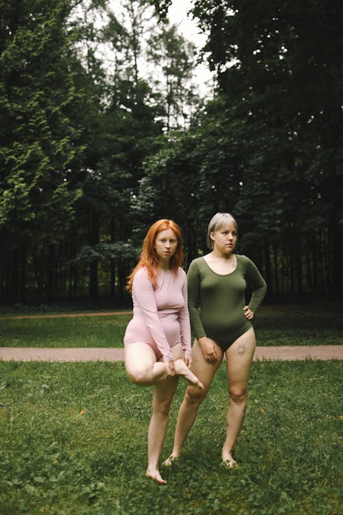 Women Wearing Bodysuit while Standing on the Field