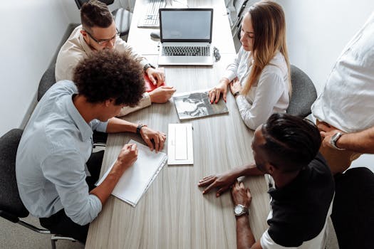 Group of diverse professionals collaborating in a modern office setting.