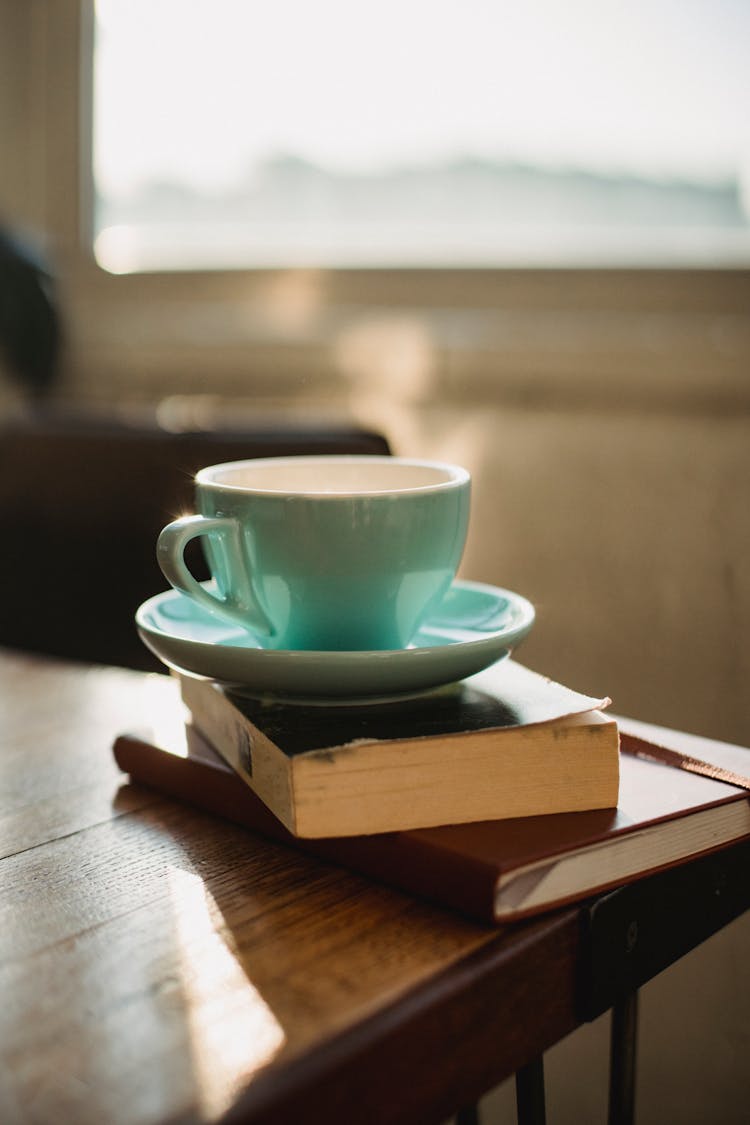 Cup Of Hot Beverage On Books