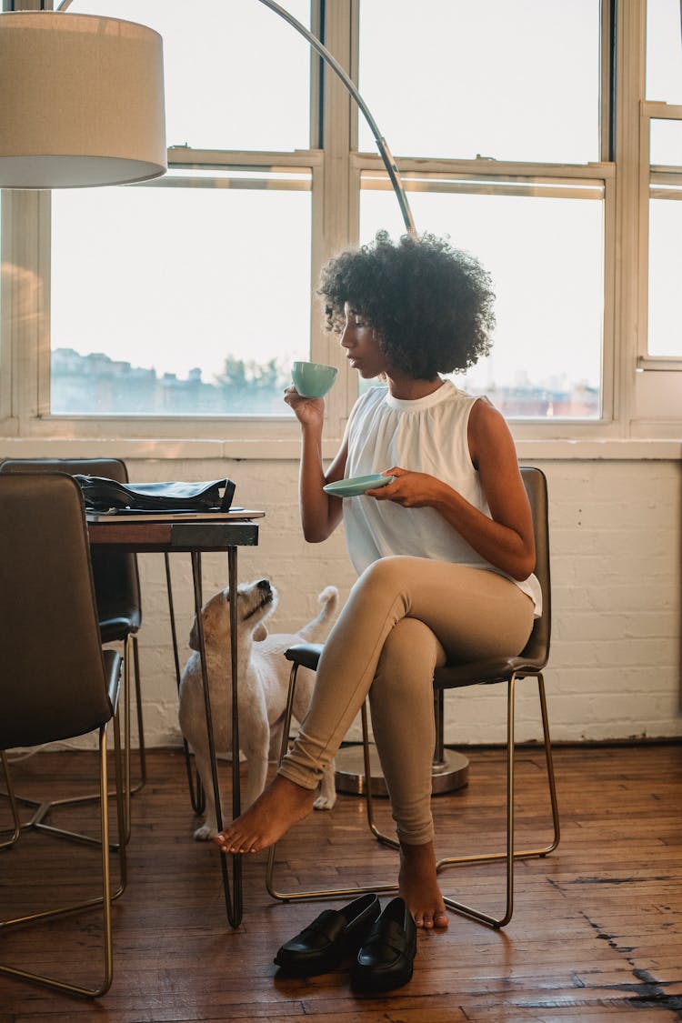 Black Woman Drinking Coffee At Home