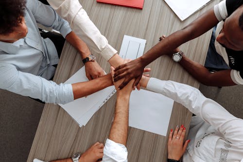 people joining hands together