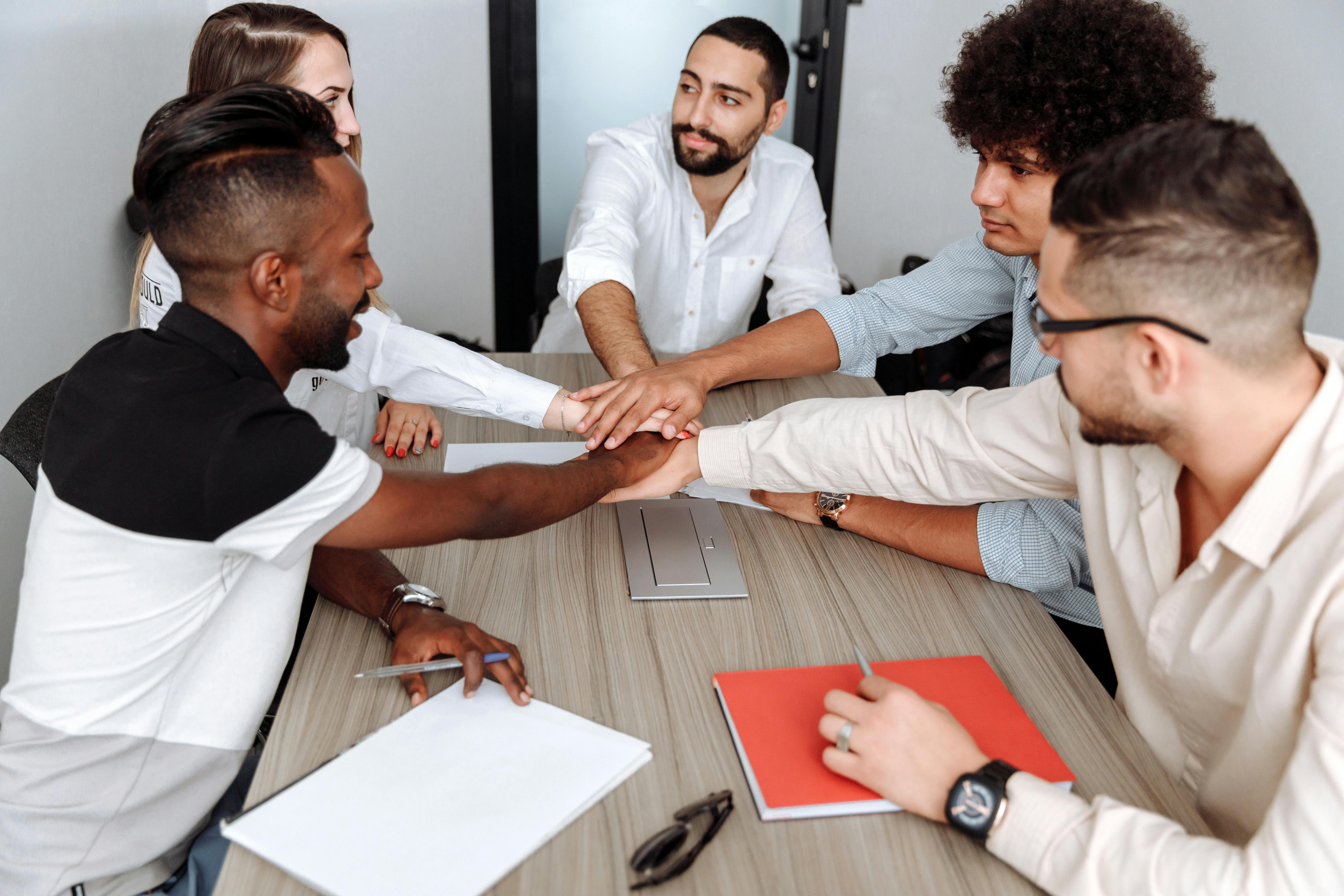 colleagues with their hands together