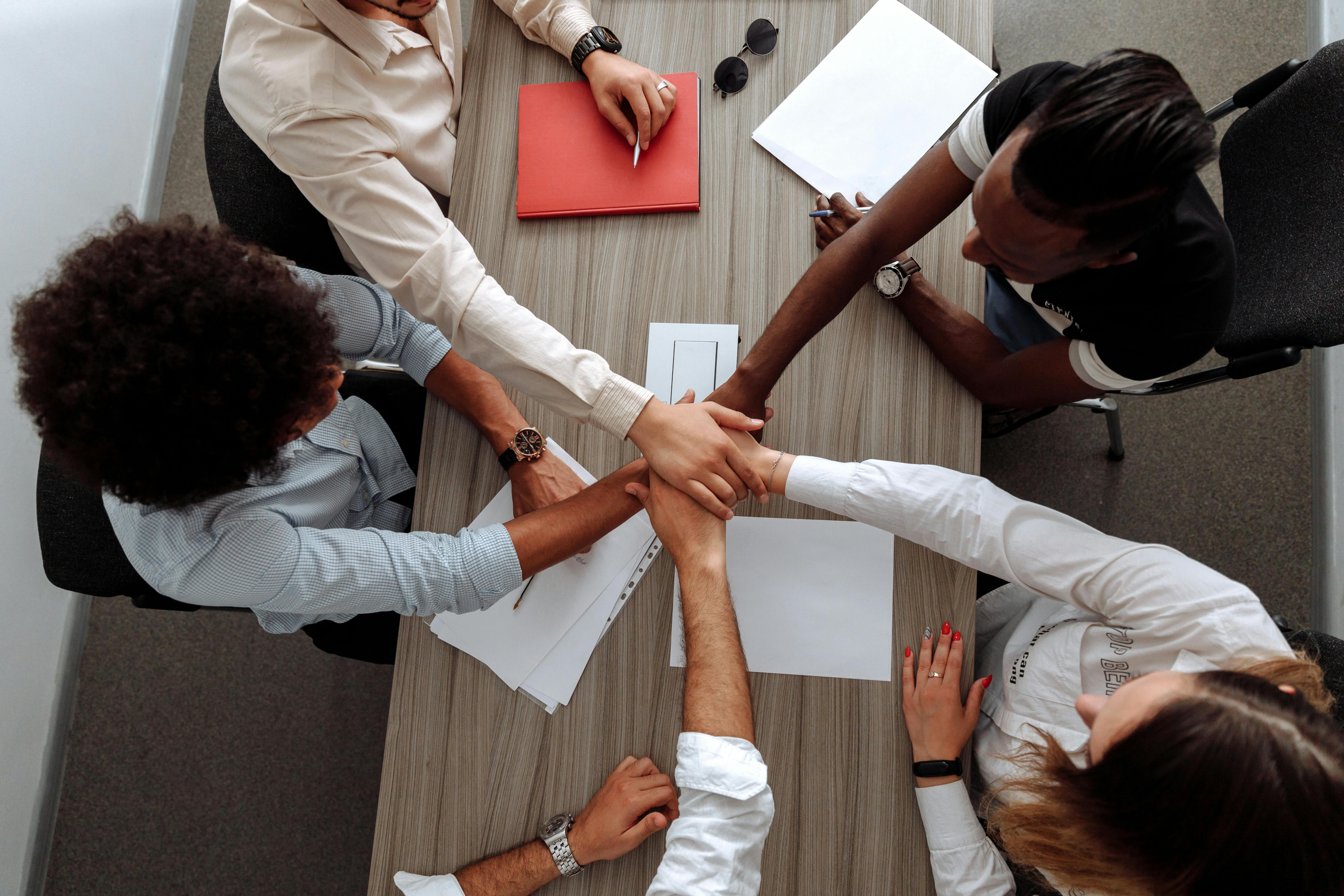 coworkers with their hands together