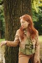 Woman in Brown Jacket Standing Beside Tree