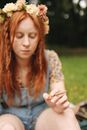 Woman in Blue and Yellow Floral Shirt Holding Cigarette Stick