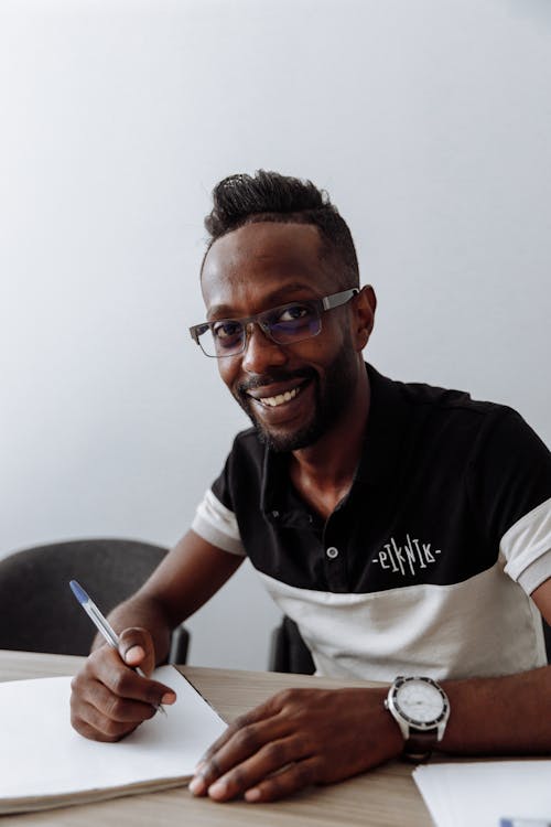 Man in Polo Shirt Holding a pen