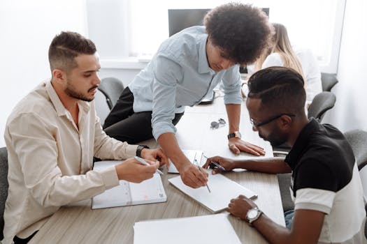 A diverse team of professionals collaborating in a modern office setting, focusing on brainstorming and planning.