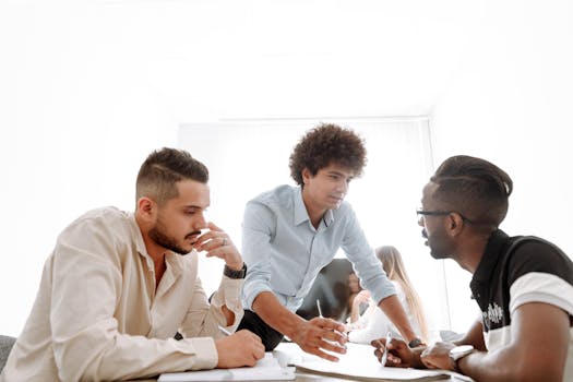 Diverse group of young professionals engaged in a collaborative office meeting.