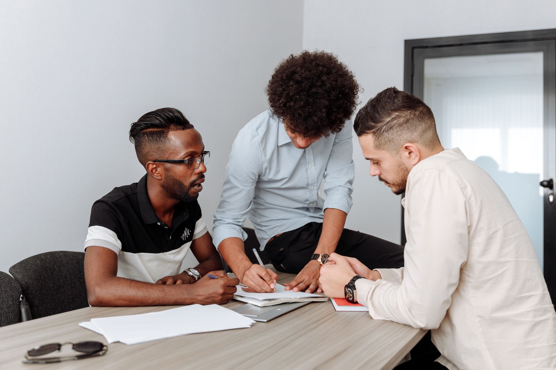 Colleagues discussing tender evidence in a meeting