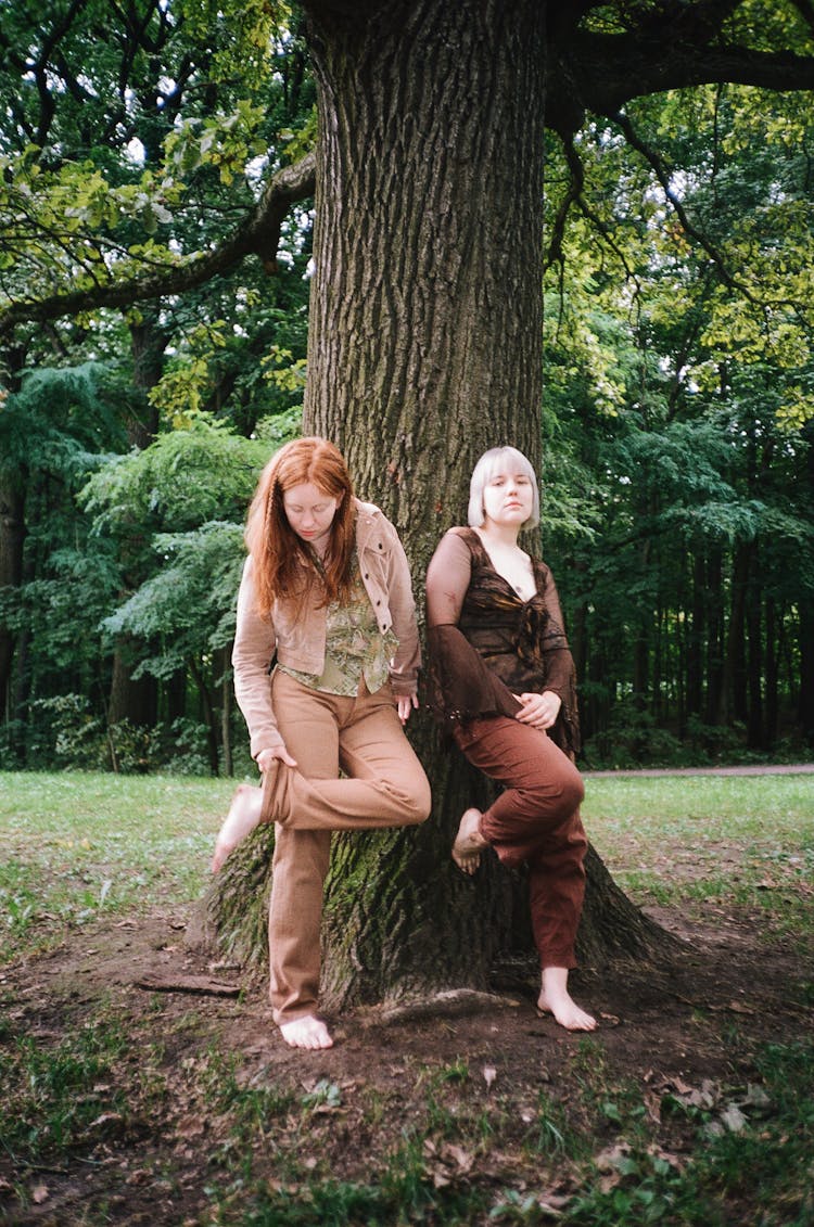 Women Standing Beside The Tree