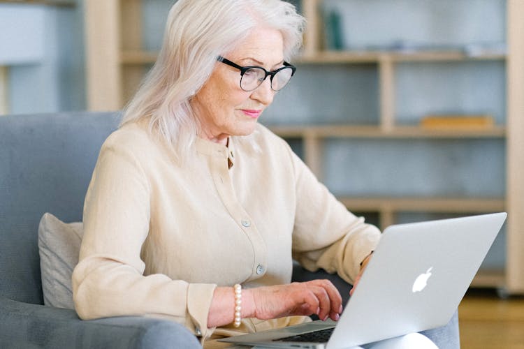 An Elderly Woman Using A Laptop