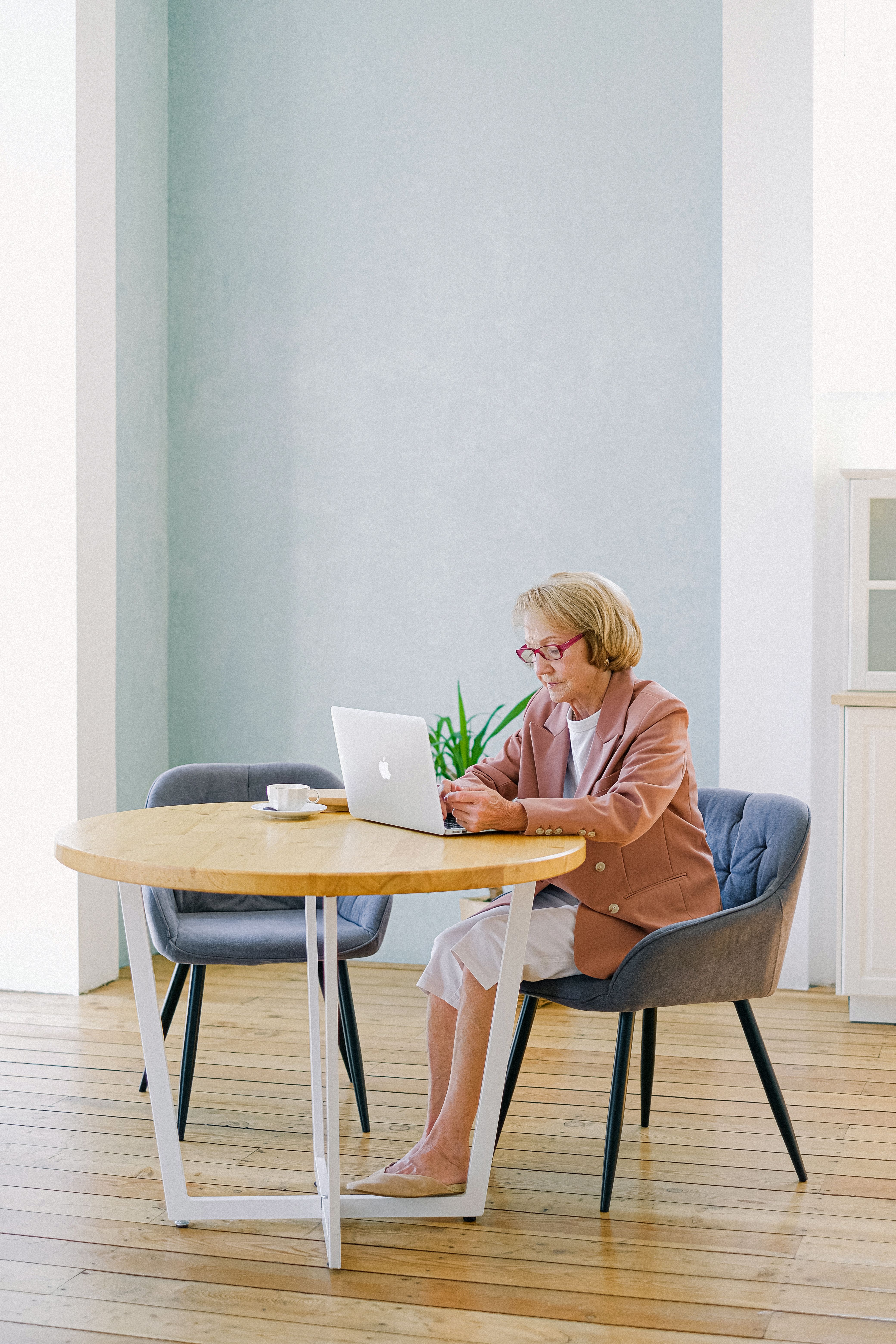 Older woman using a laptop in a bright room