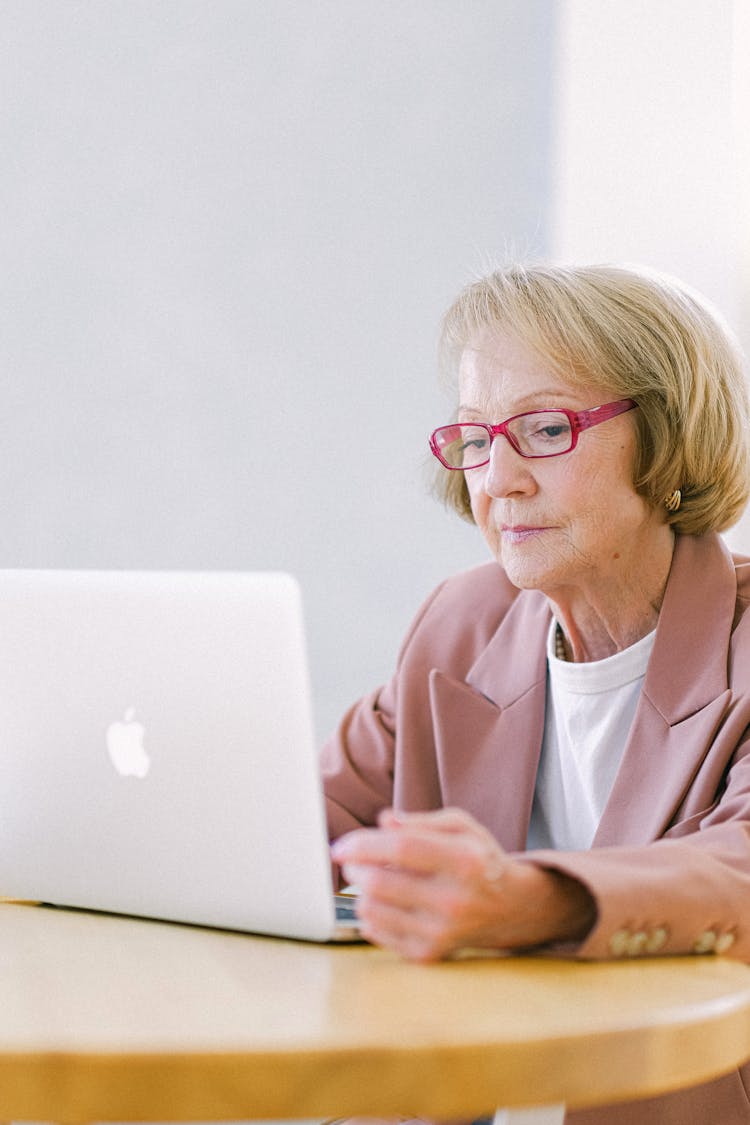 Serious Senior Woman Creating Business Project On Laptop