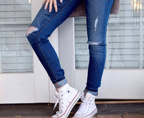 Person in Blue Denim Jeans and White Converse All Stars