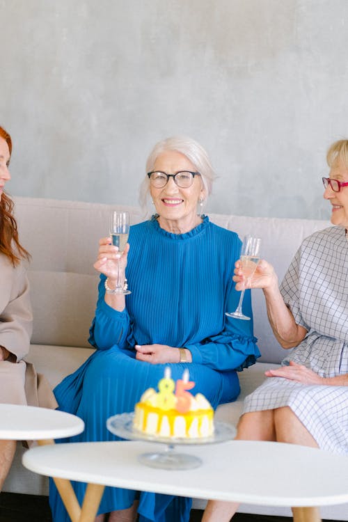 Free Happy aged women with glasses of champagne smiling Stock Photo