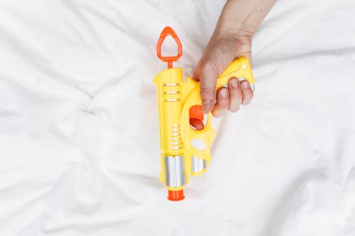 Free Person Holding Toy Gun Stock Photo