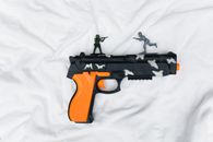Plastic Pistol on White Sheet