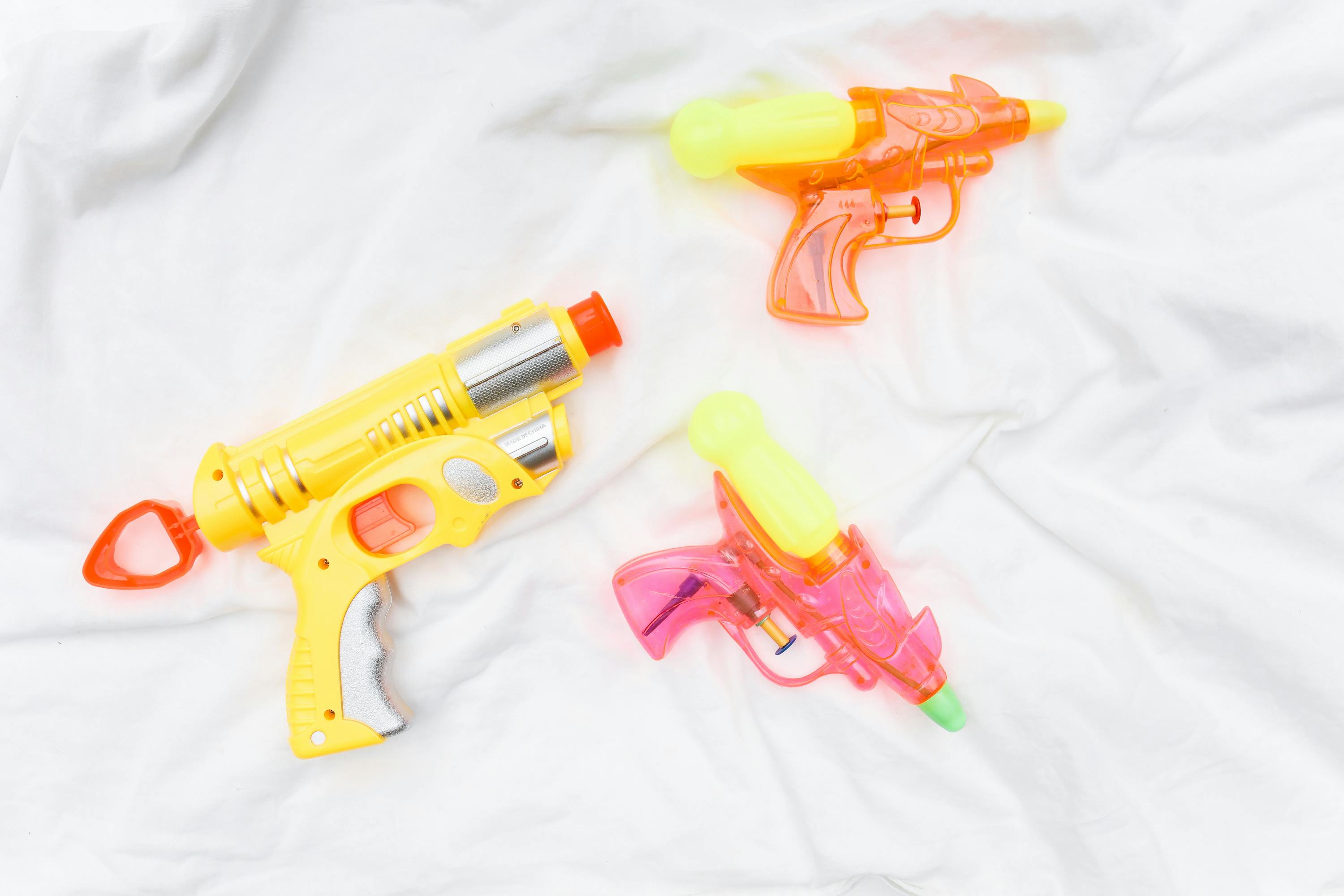 studio shot of vibrant coloured plastic water guns