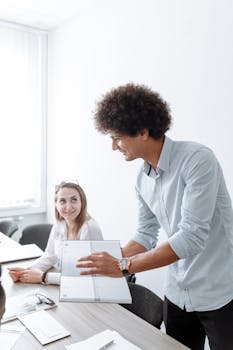 Professional team engaged in a collaborative discussion during a meeting in a bright, modern office.