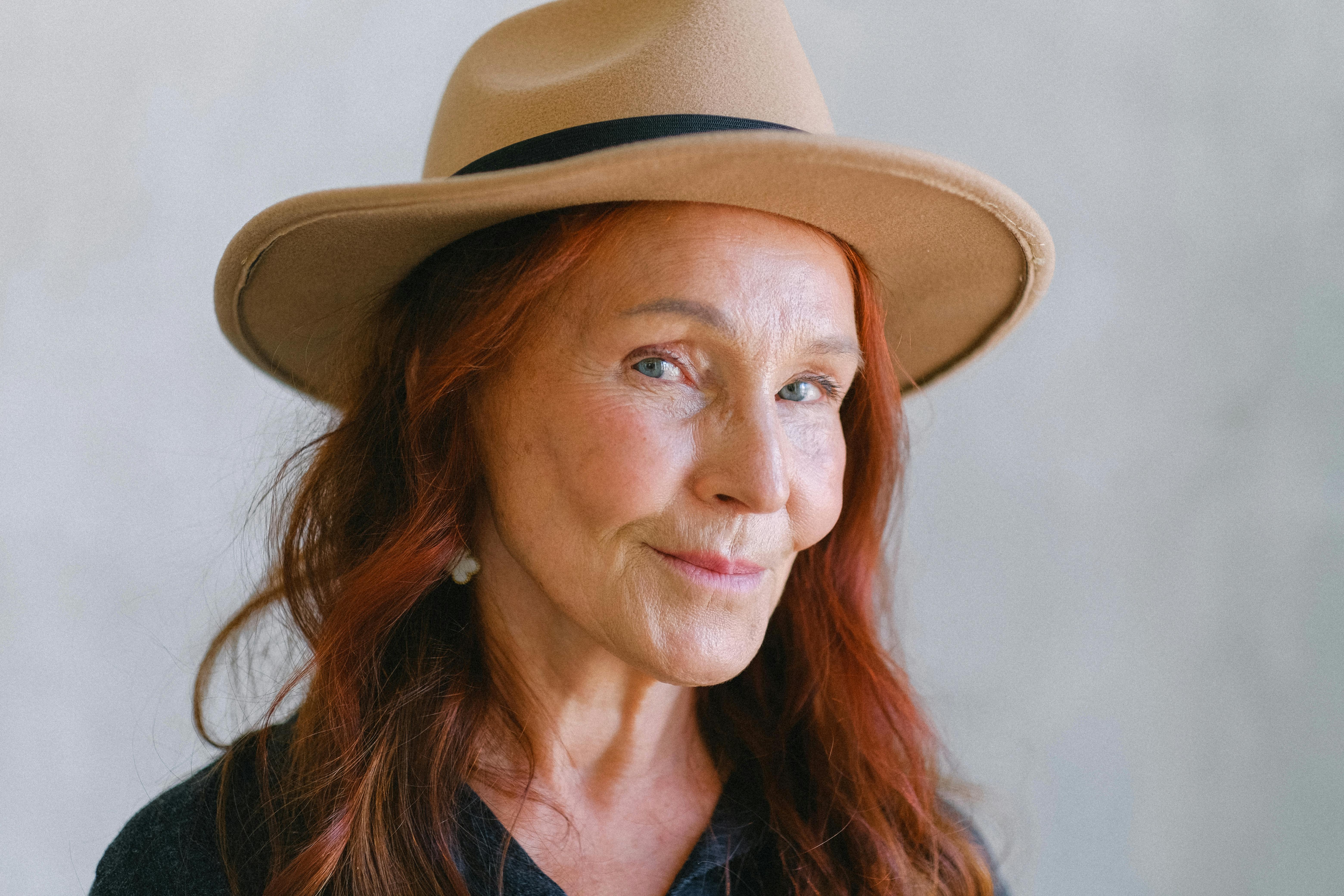 elderly woman in stylish hat smiling at camera