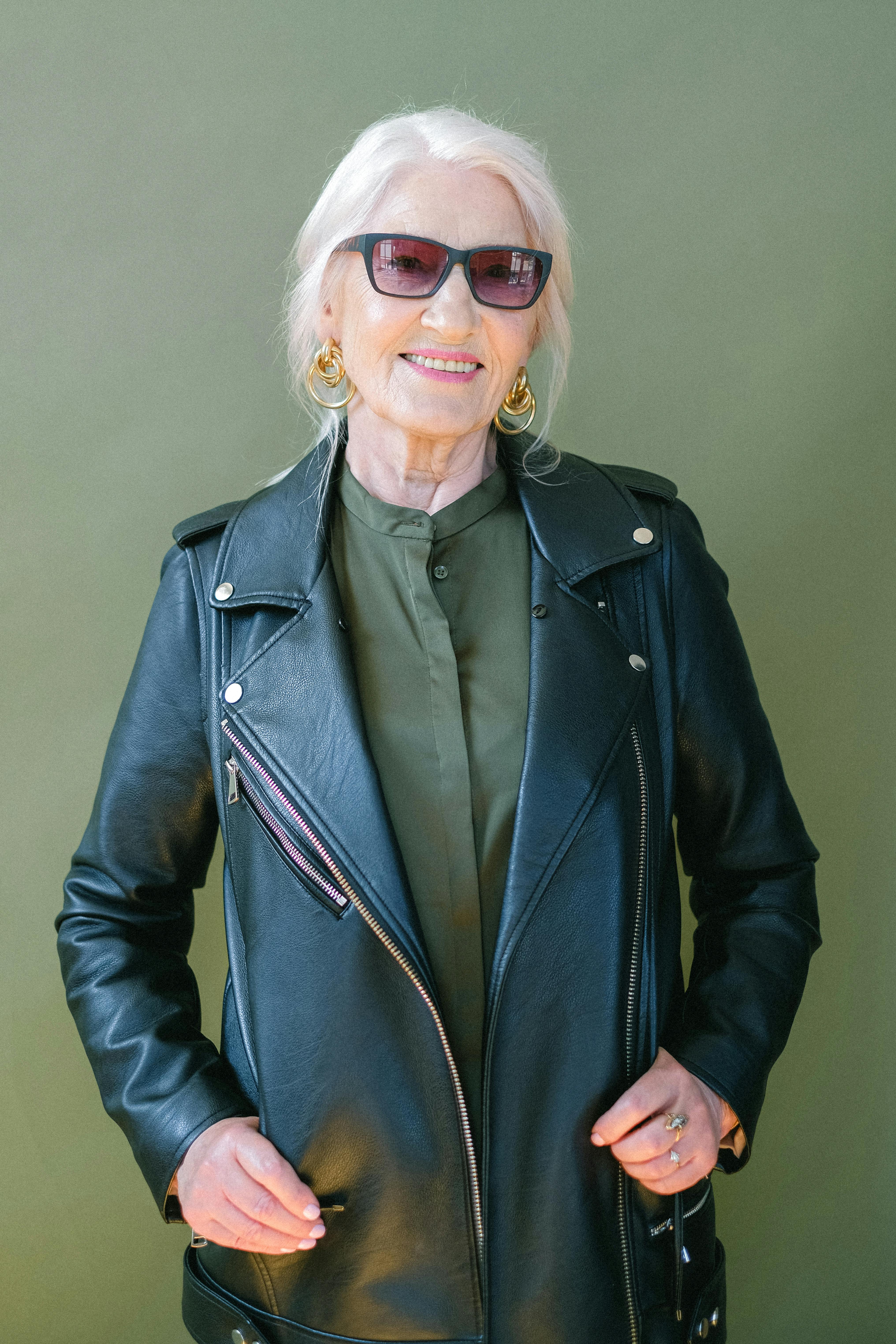 Trendy senior happy woman in sunglasses and stylish leather jacket