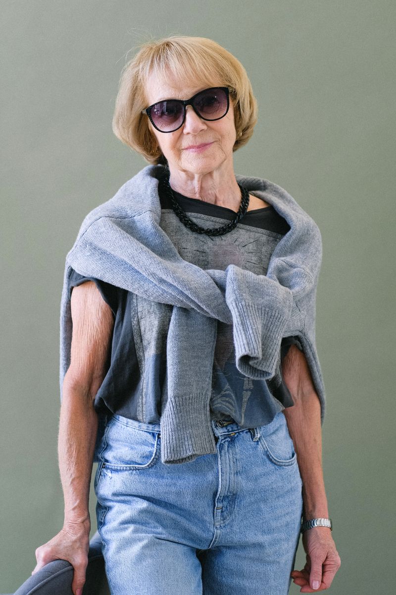 Mature woman in straight jeans with long cardigan