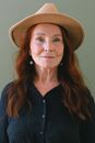 Aged woman with red hair in trendy hat