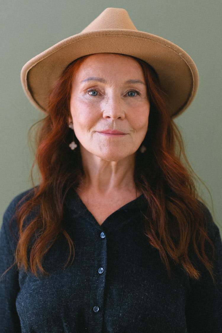 Aged Woman With Red Hair In Trendy Hat