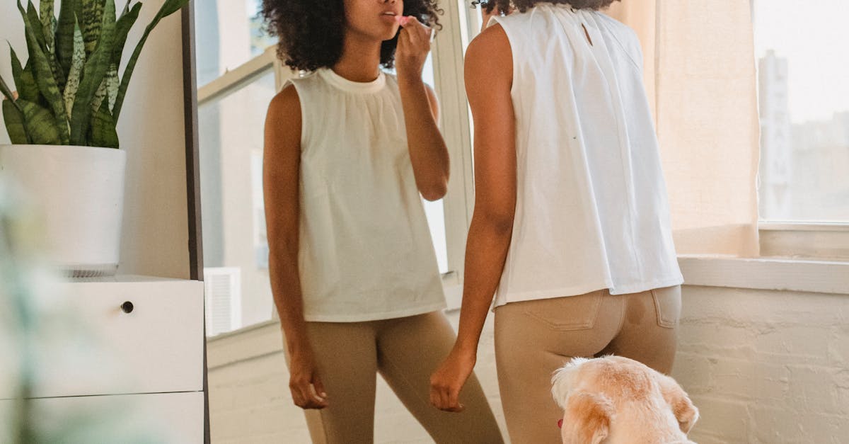 Black woman doing makeup at home