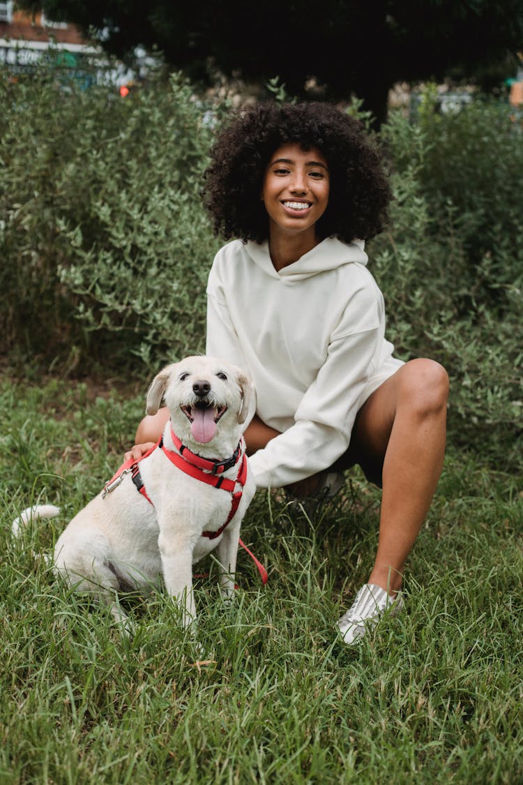 Cheerful Black Woman With Dog In Park