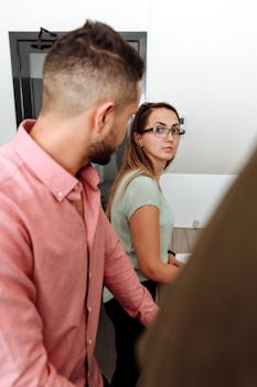 Professional office setting with colleagues engaged in a team discussion, showcasing diversity and collaboration.