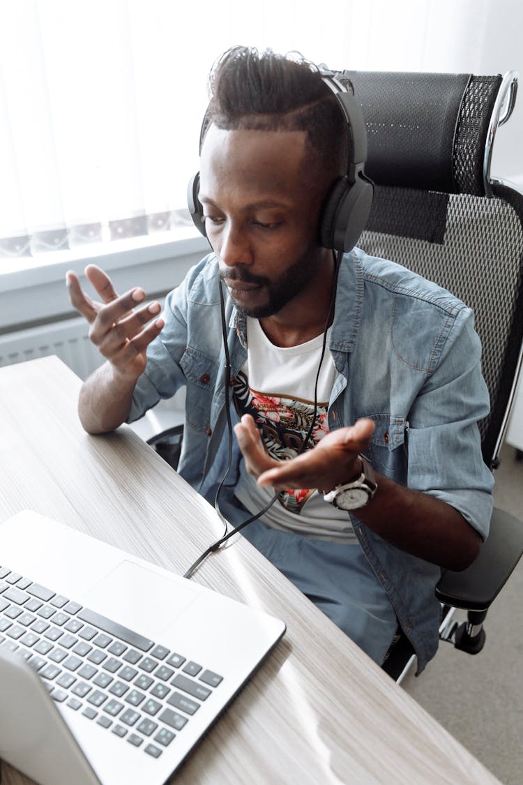 Man In Blue Button Up Shirt Sitting On Gray Office Rolling Chair