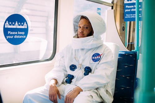 Free Man Wearing An Astronaut Costume Inside A Train Stock Photo