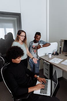 Group of professionals collaborating on a project in a modern office environment.